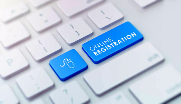 High quality 3d render of a modern keyboard with blue online registration button.  Online registration keyboard button has a text and an icon on it and it is in focus.  Horizontal  composition with copy space.